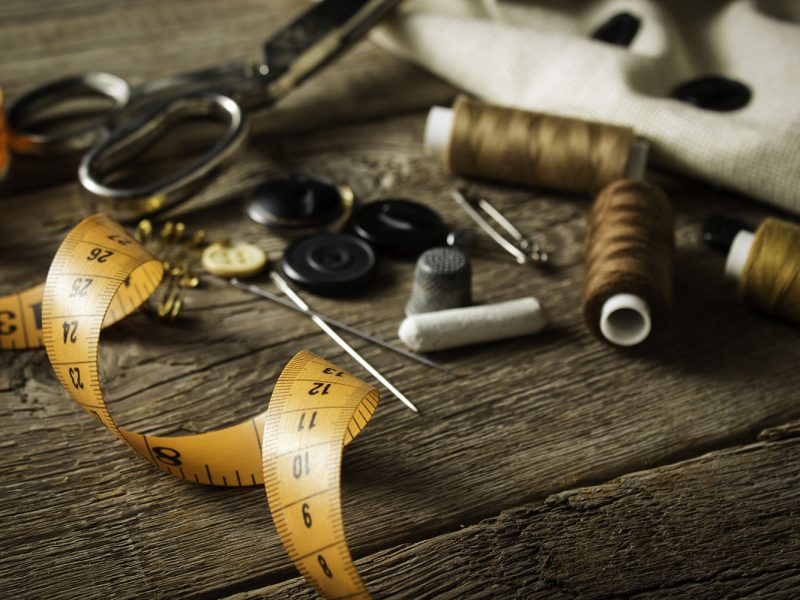 Sewing accessories on wooden background